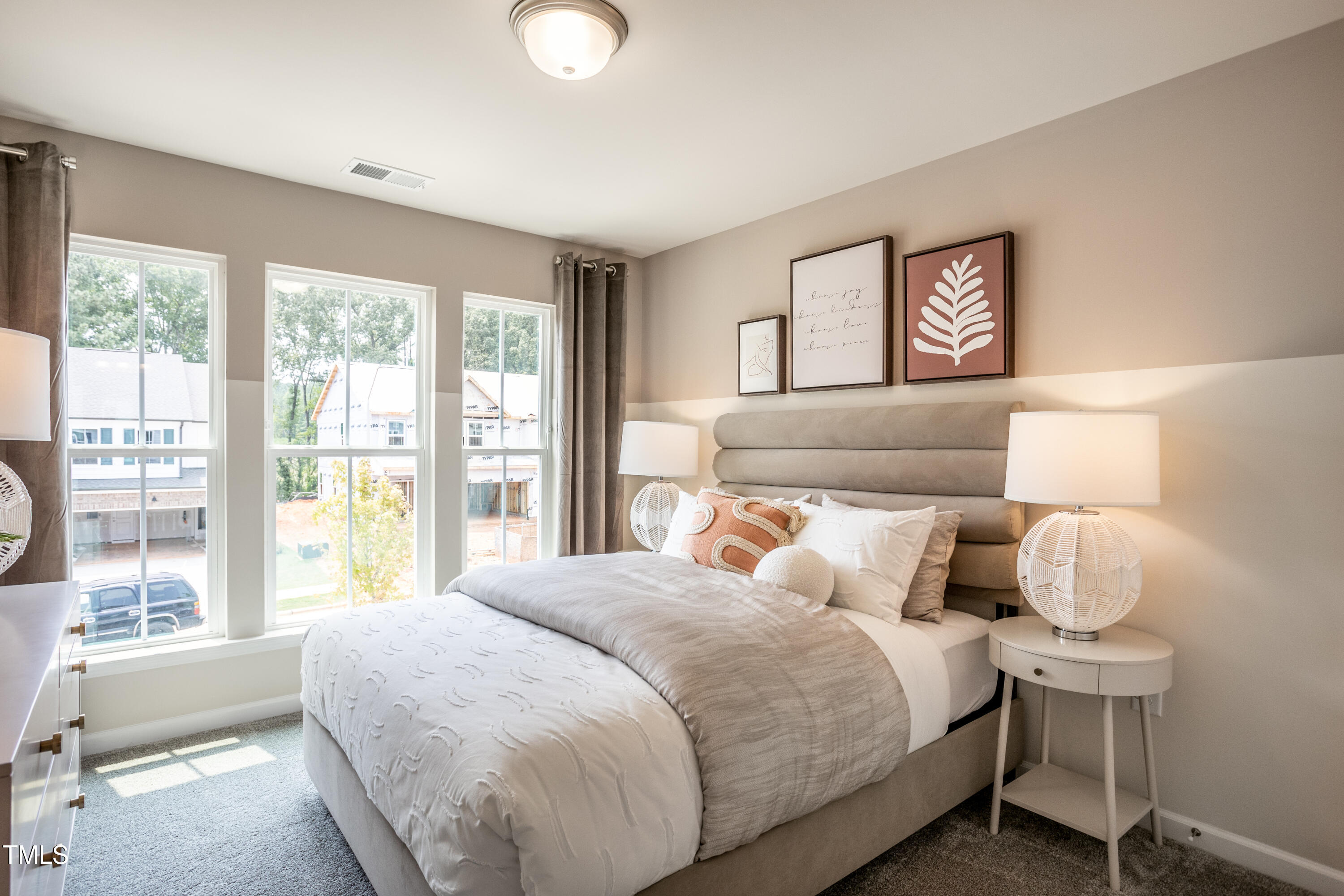 242 Broomside Avenue Raleigh, NC 27603 - Photo 12 of 22 a bedroom with a large bed and a large window
