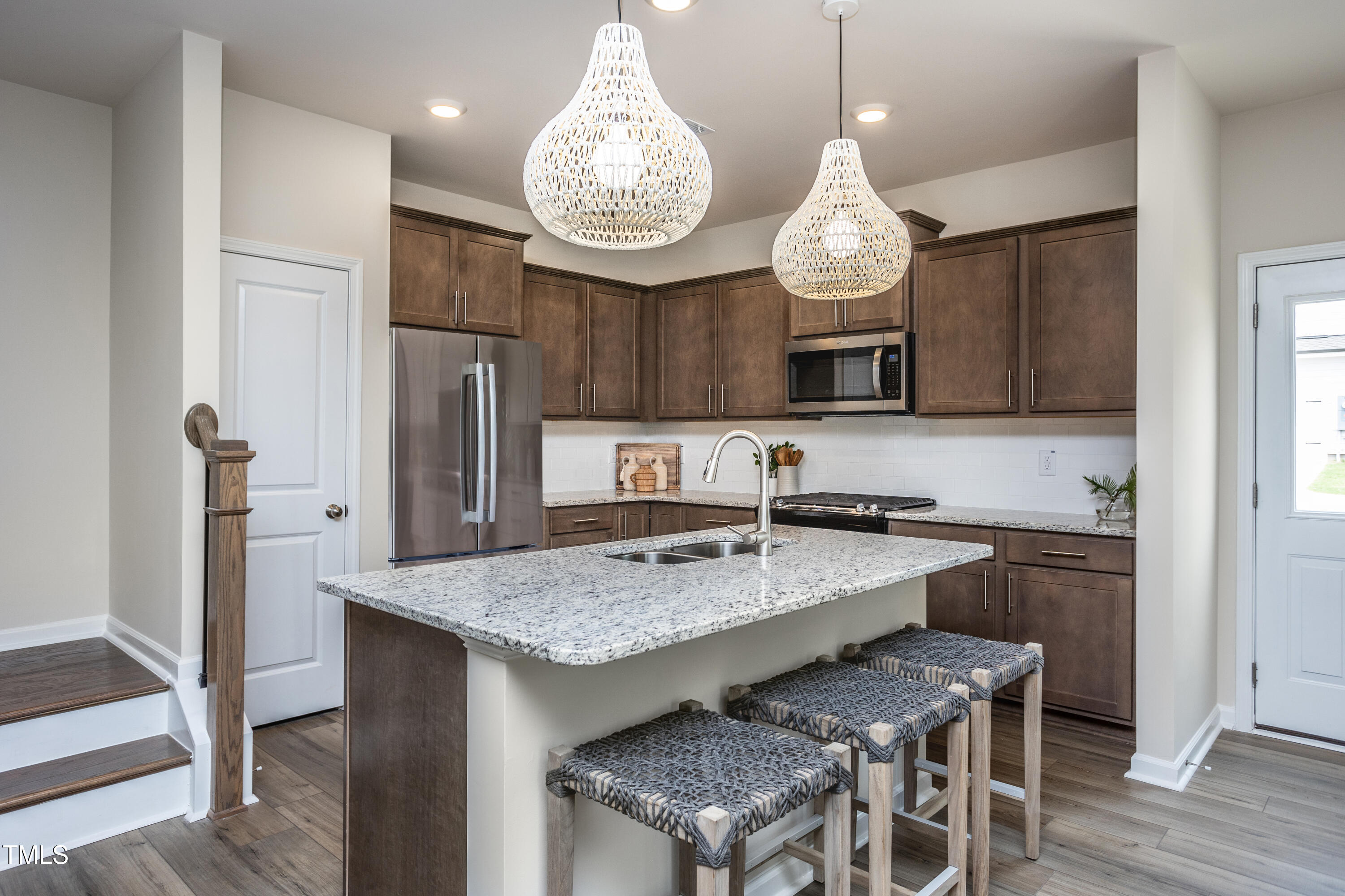 242 Broomside Avenue Raleigh, NC 27603 - Photo 2 of 22 a very nice looking kitchen with granite countertop a stove oven and a refrigerator