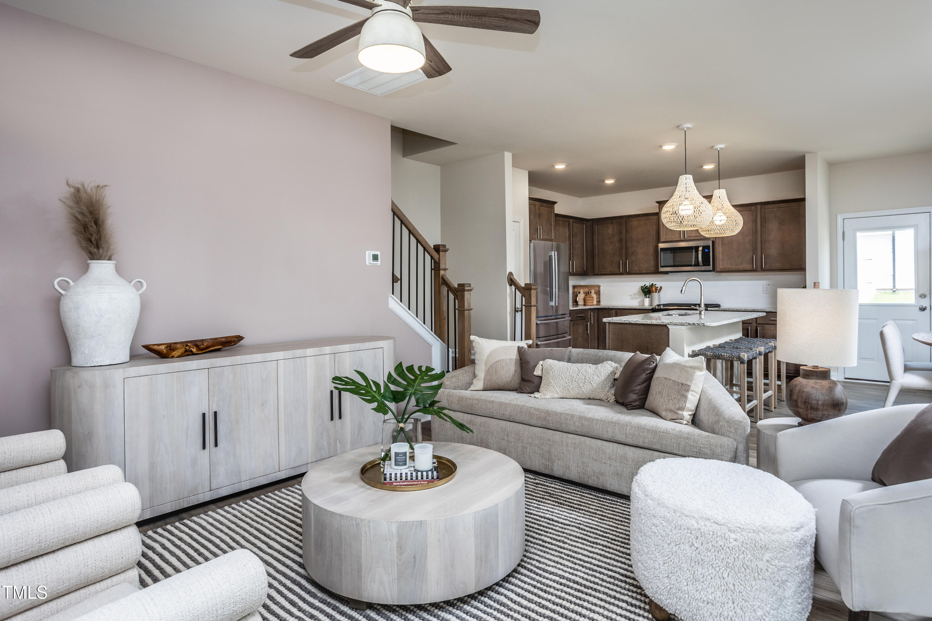 242 Broomside Avenue Raleigh, NC 27603 - Photo 8 of 22 a living room with furniture kitchen view and a chandelier