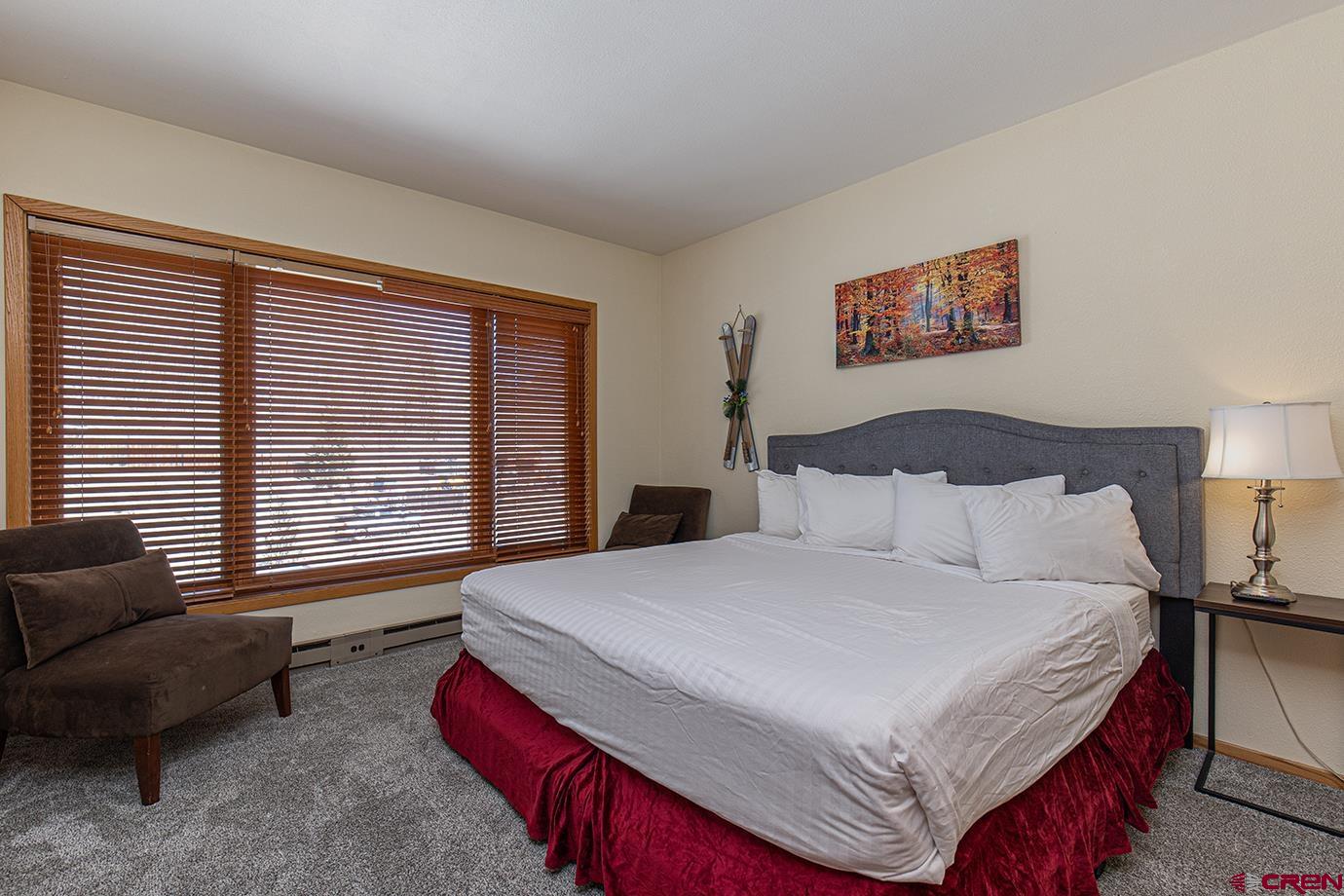 93 Needles Way, Unit 514 Durango, CO 81301 - Photo 14 of 34 a bedroom with a bed a couch and a large window