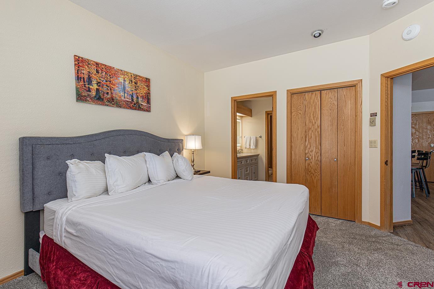 93 Needles Way, Unit 514 Durango, CO 81301 - Photo 15 of 34 a large bed in a white room