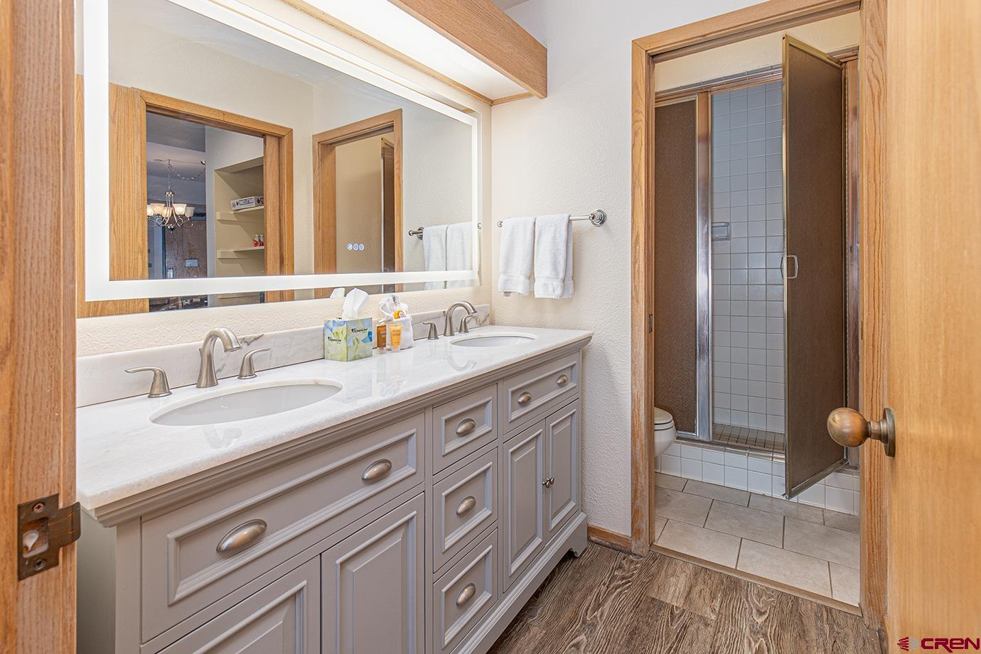93 Needles Way, Unit 514 Durango, CO 81301 - Photo 16 of 34 a bathroom with a granite countertop sink mirror and double