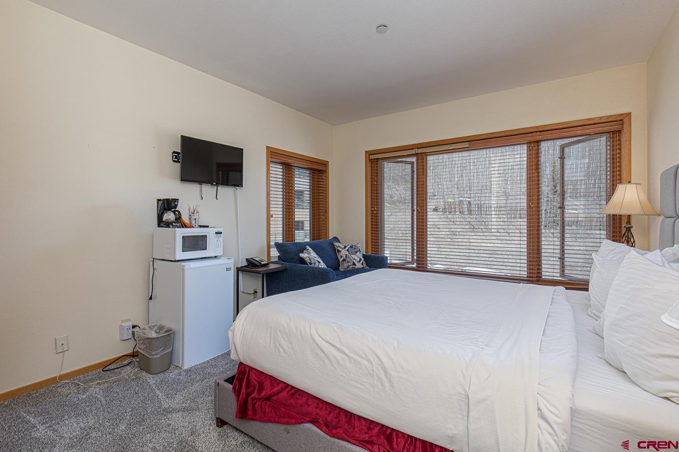 93 Needles Way, Unit 514 Durango, CO 81301 - Photo 18 of 34 a bedroom with a bed and a flat screen tv