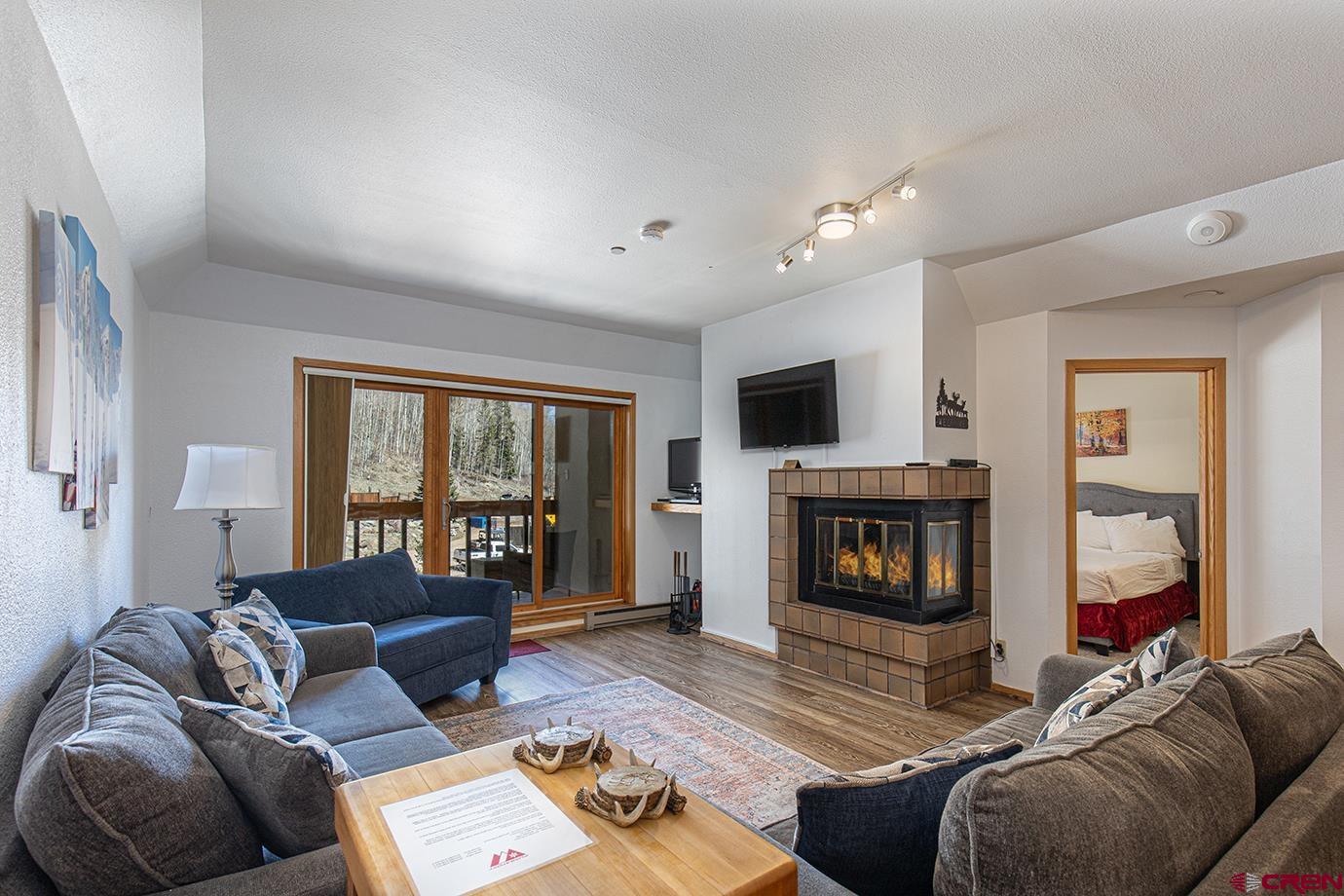 93 Needles Way, Unit 514 Durango, CO 81301 - Photo 3 of 34 a living room with furniture and a fireplace