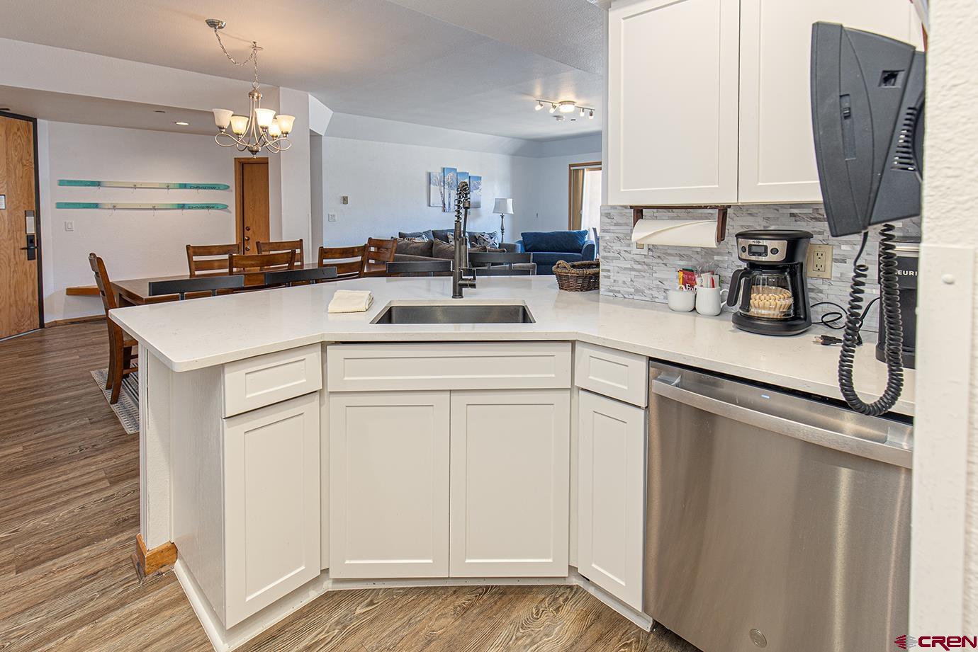 93 Needles Way, Unit 514 Durango, CO 81301 - Photo 5 of 34 a kitchen with cabinets appliances and a counter