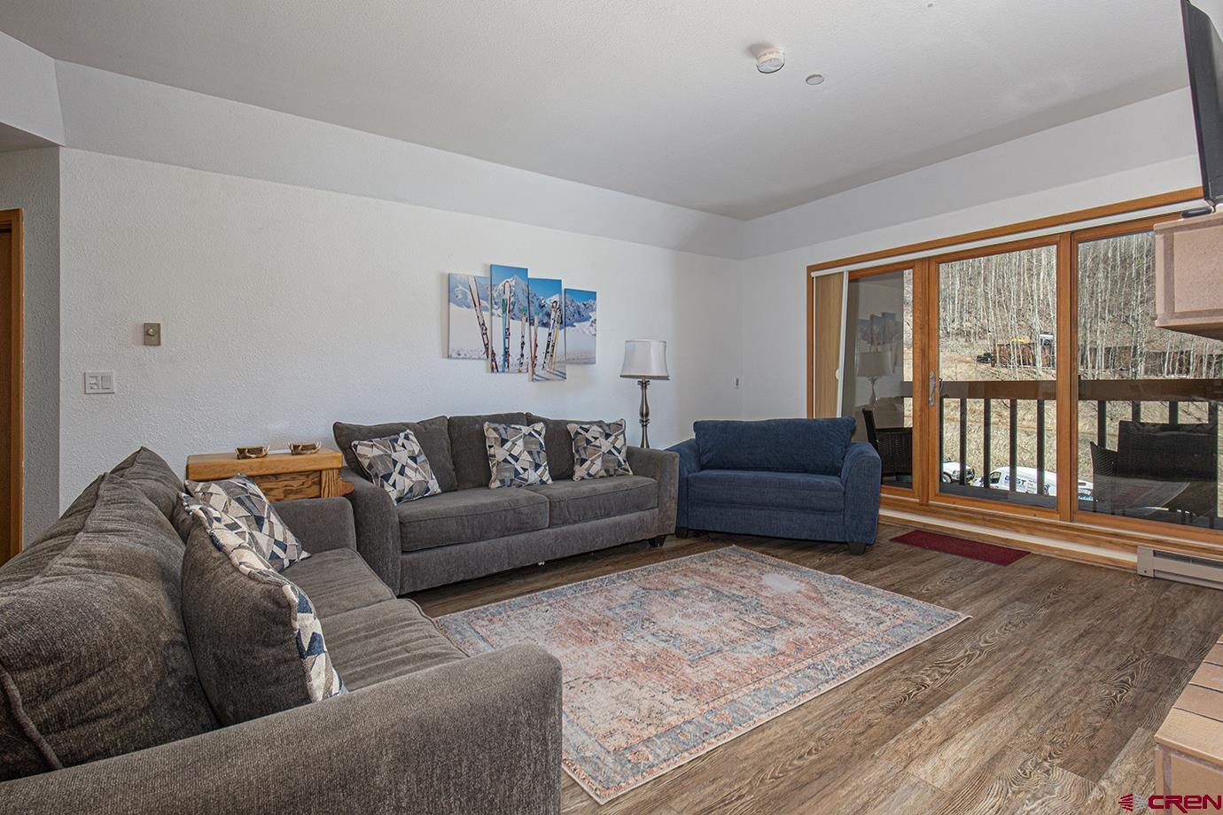 93 Needles Way, Unit 514 Durango, CO 81301 - Photo 7 of 34 a living room with furniture and a floor to ceiling window