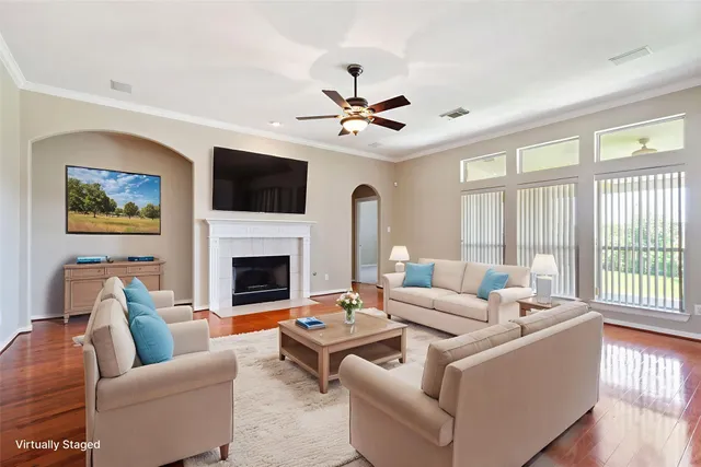 a living room with furniture fireplace and a flat screen tv