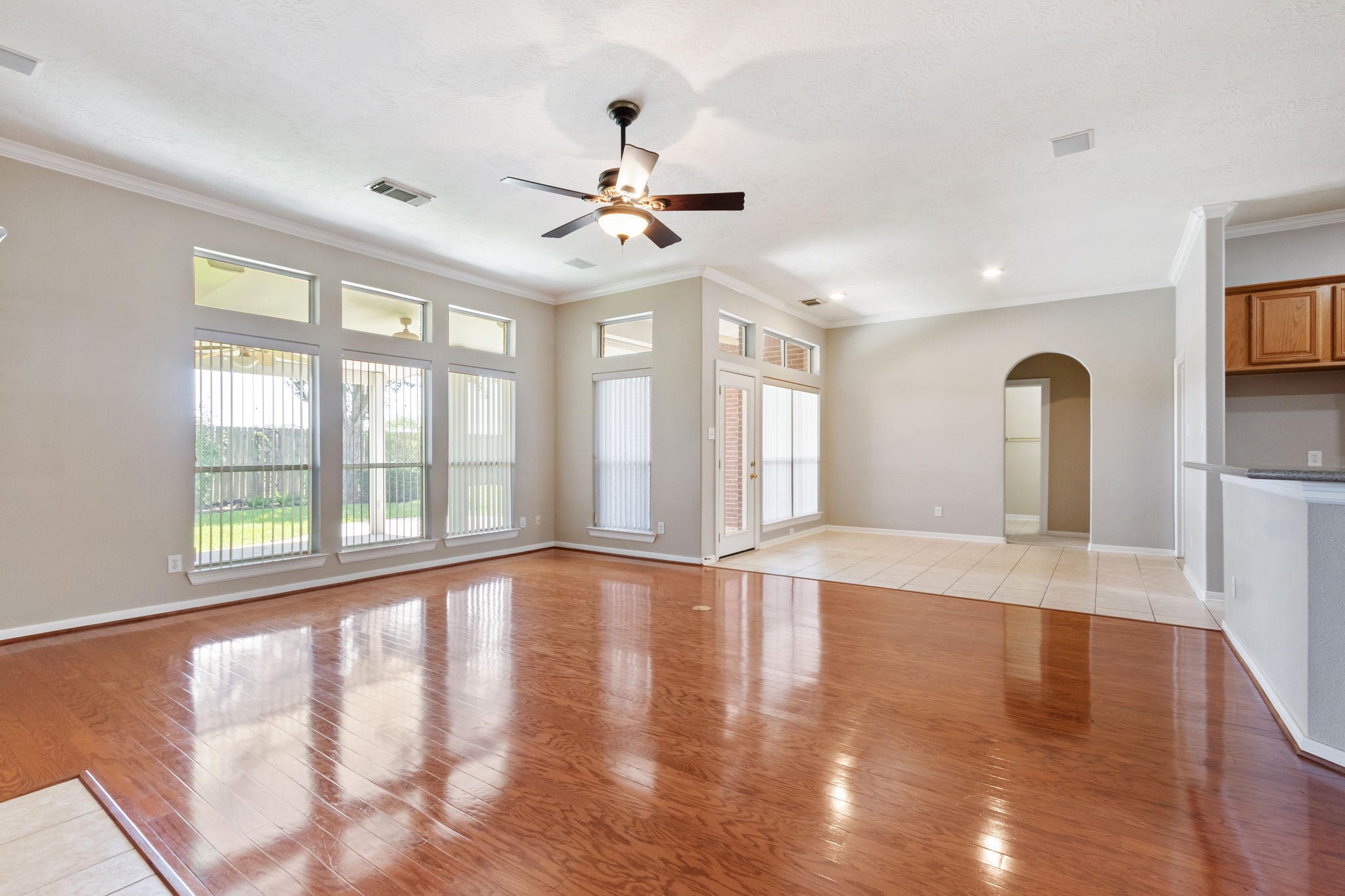 6311 Stone Trail Lane Spring, TX 77379 - Photo 12 of 47 The open concept living room and kitchen is light and bright with a wall of windows looking out to the beautiful backyard