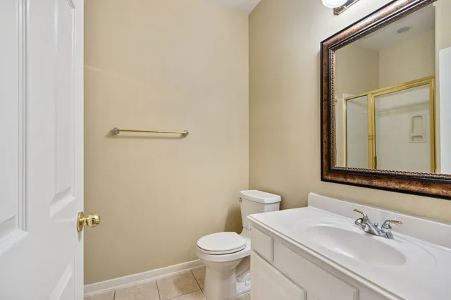 a bathroom with a sink toilet and mirror