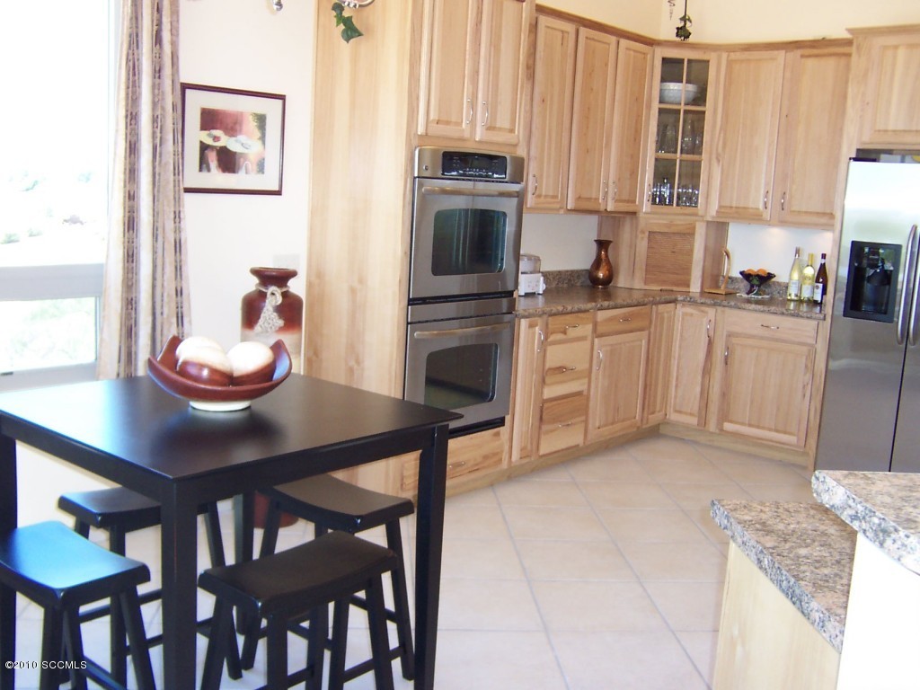 530 Ruth Lane Rio Rico, AZ 85648 - Photo 4 of 36 a kitchen with stainless steel appliances granite countertop a stove a sink and a refrigerator