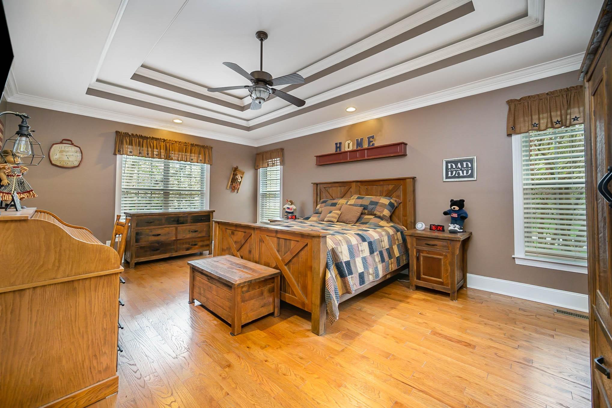 6700 Fox Ridge Circle Davidson, NC 28036 - Photo 20 of 48 a bedroom with a bed and a chandelier