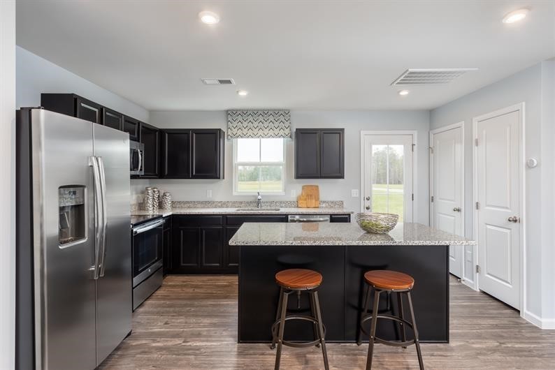 628 Merle Avenue Franklin, KY 42134 - Photo 2 of 12 a kitchen with stainless steel appliances granite countertop a sink a stove a refrigerator cabinets and chairs