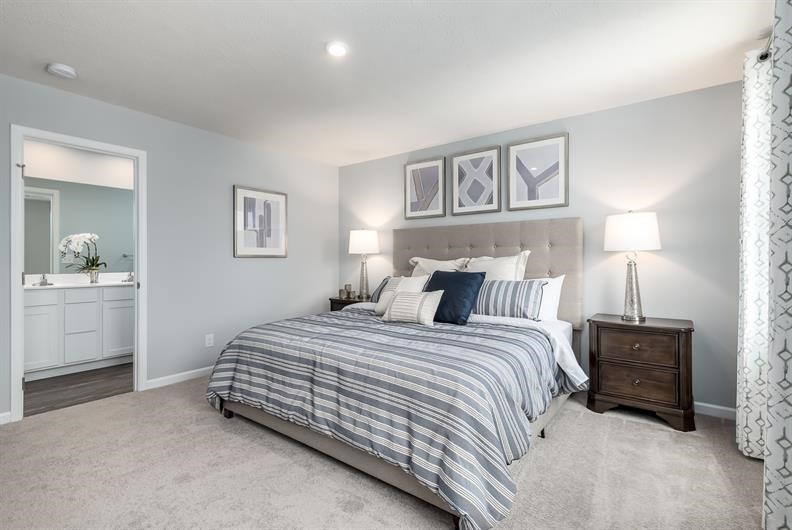 628 Merle Avenue Franklin, KY 42134 - Photo 7 of 12 a bedroom with a bed and a chandelier