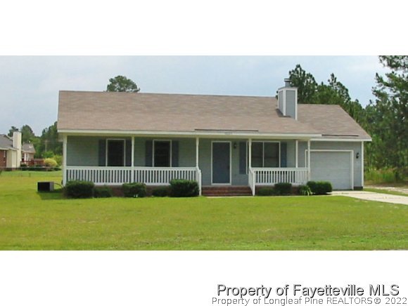 10223 Rockfish Road Raeford, NC 28376 - Photo 1 of 12 a front view of a house with a garden