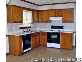 10223 Rockfish Road Raeford, NC 28376 - Photo 7 of 12 a kitchen with stainless steel appliances granite countertop a stove a sink and a microwave