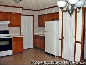 10223 Rockfish Road Raeford, NC 28376 - Photo 8 of 12 a kitchen with stainless steel appliances granite countertop a refrigerator a stove and a sink
