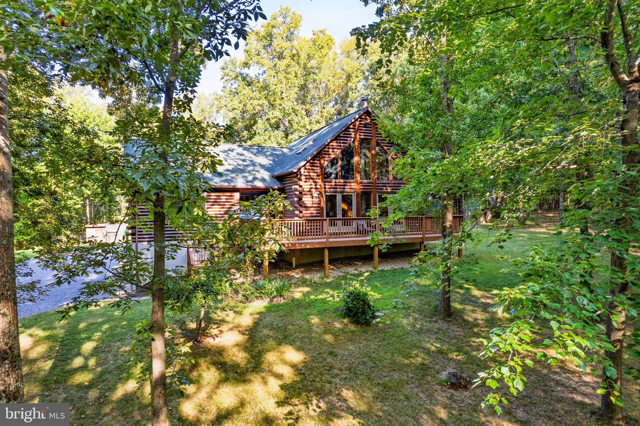 4344 Mission Road Harpers Ferry, WV 25425 - Photo 1 of 60 Charming log cabin nestled in lush greenery.