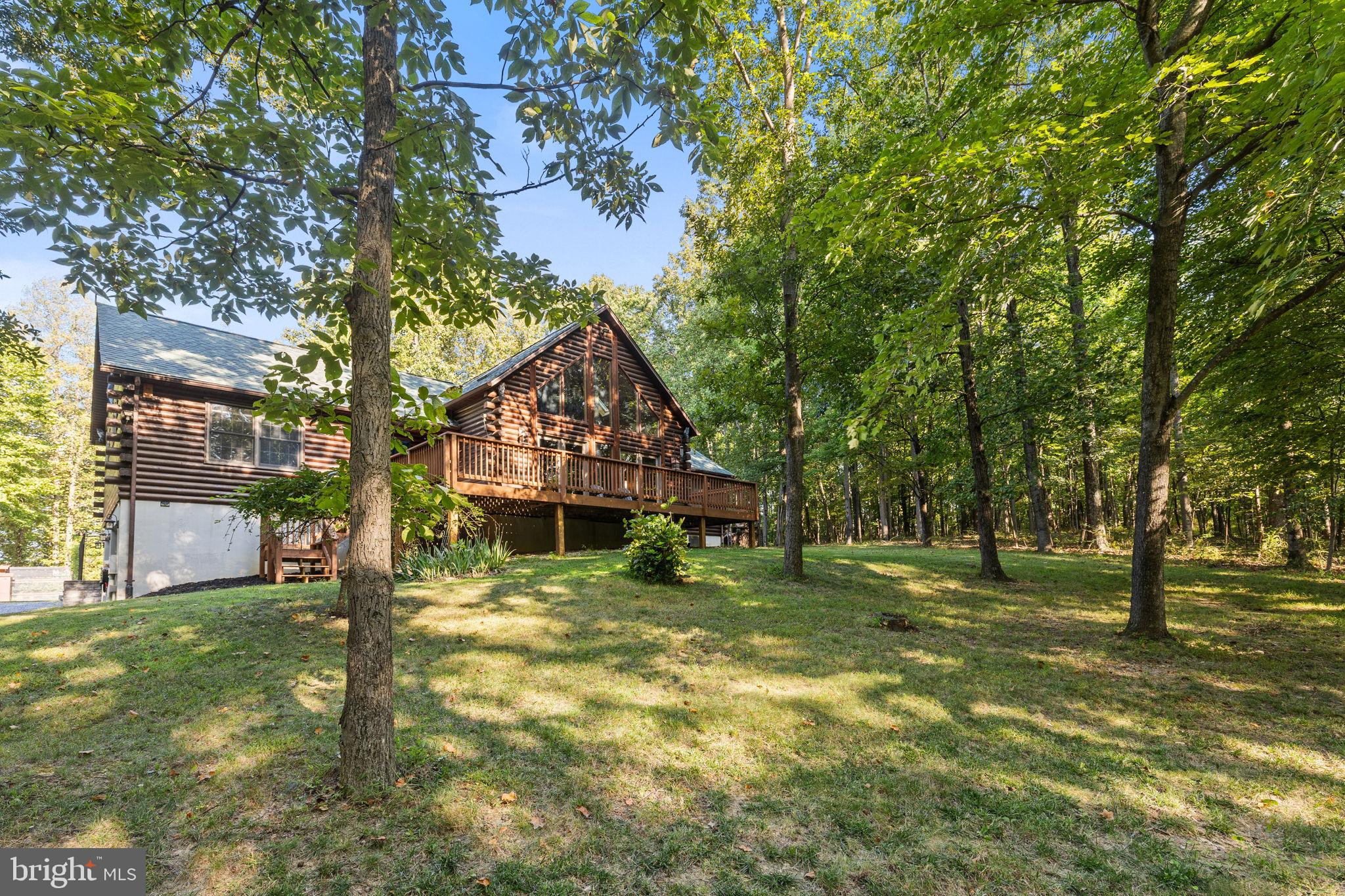 4344 Mission Road Harpers Ferry, WV 25425 - Photo 4 of 60 Charming log cabin nestled in lush greenery.