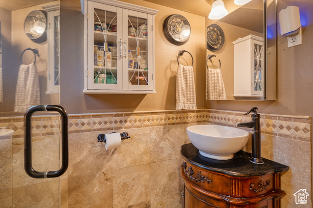 714 Spotted Fawn Way Kamas, UT 84036 - Photo 16 of 34 Bathroom featuring tile walls, vanity, and a wainscoted wall