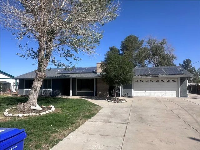 a view of a house with backyard porch and sitting area