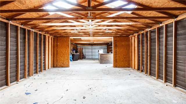 a view of empty room with wooden floor and fireplace