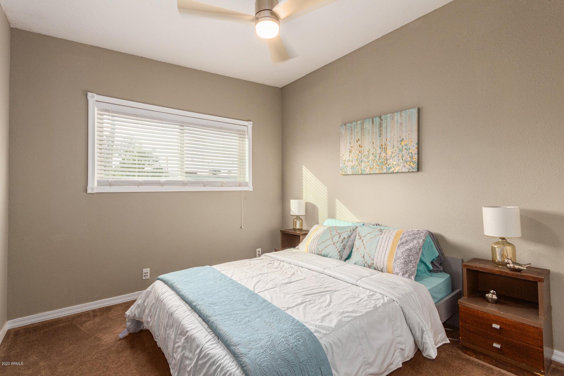 1732 North Queensbury Mesa, AZ 85201 - Photo 14 of 27 a bedroom with a bed and a lamp on dresser