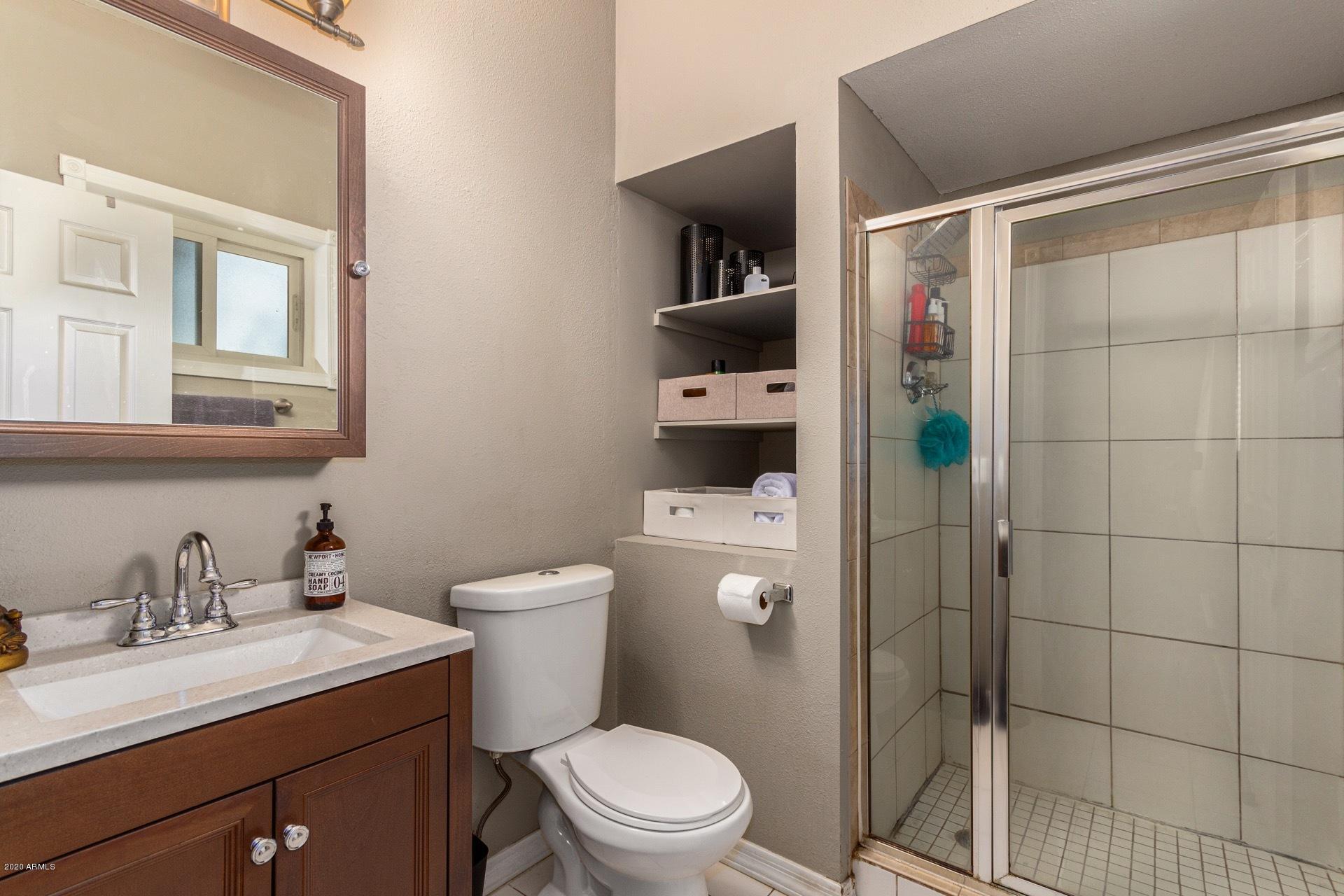 1732 North Queensbury Mesa, AZ 85201 - Photo 21 of 27 a bathroom with a toilet sink vanity and shower