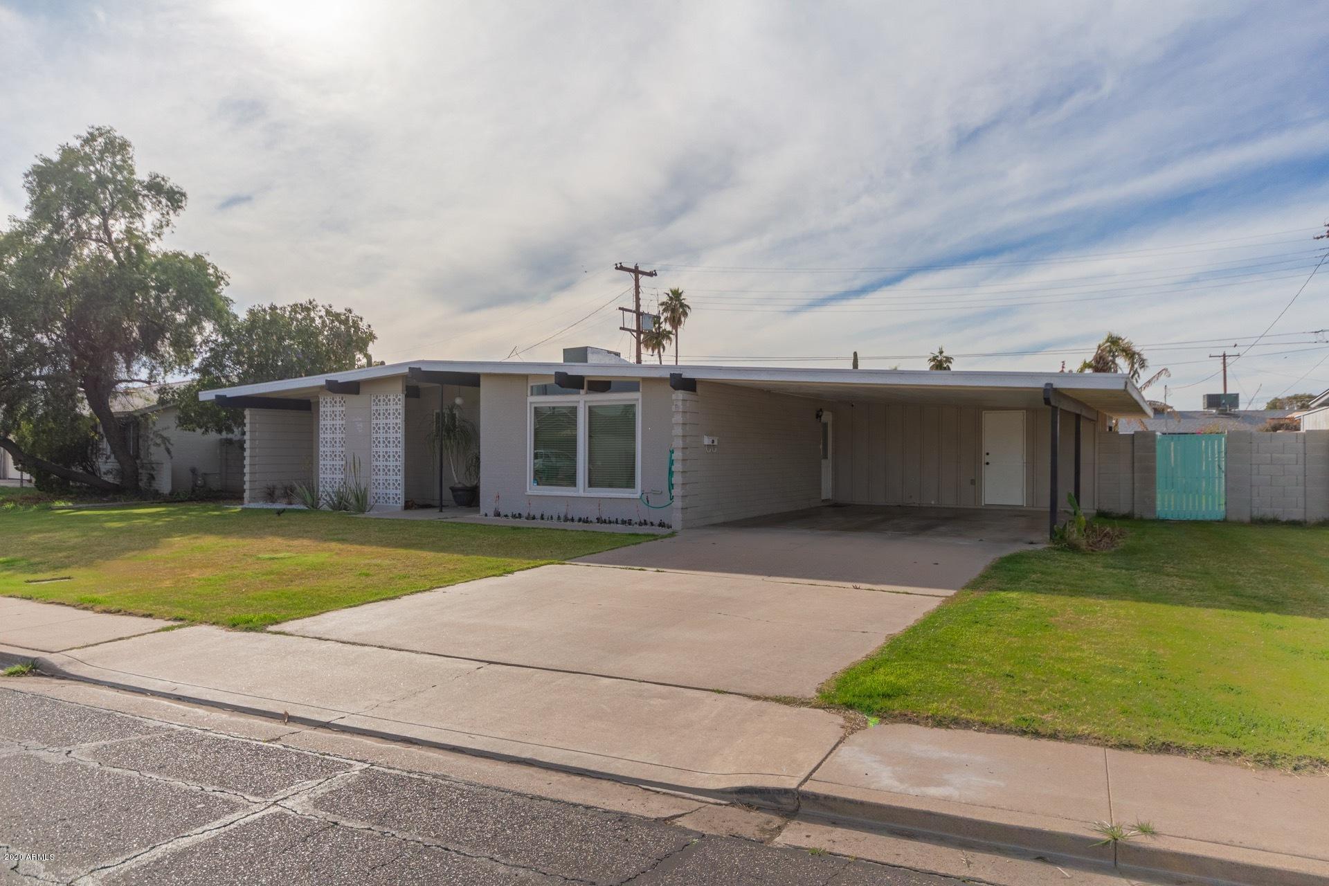 1732 North Queensbury Mesa, AZ 85201 - Photo 4 of 27 a front view of a house with a yard and garage