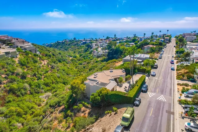 a green field with lots of trees in front of it