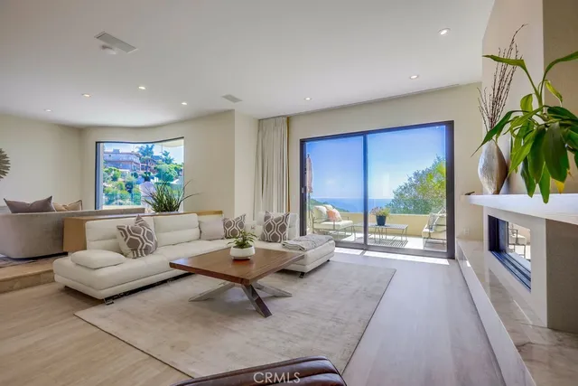 a living room with furniture potted plant and a large window