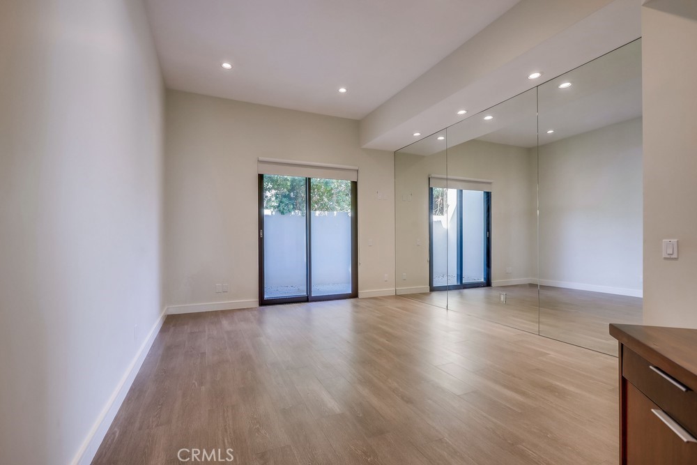 1725 Del Mar Avenue Laguna Beach, CA 92651 - Photo 42 of 63 an empty room with wooden floor and windows