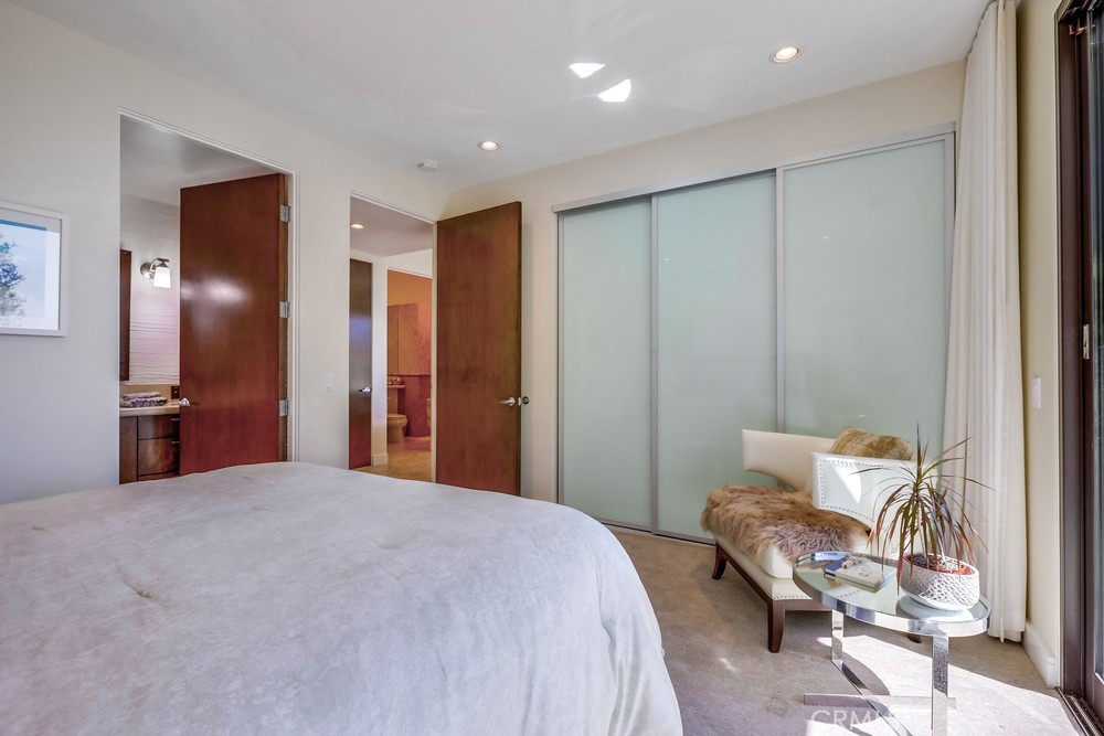 1725 Del Mar Avenue Laguna Beach, CA 92651 - Photo 48 of 63 a bedroom with a bed and a chair