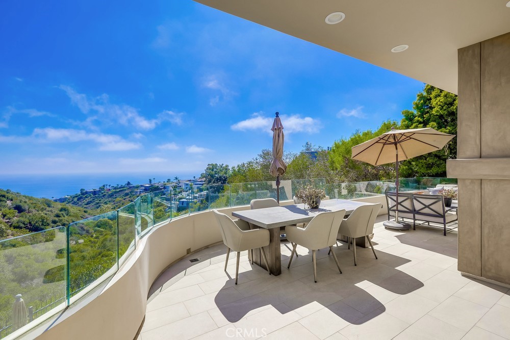 1725 Del Mar Avenue Laguna Beach, CA 92651 - Photo 60 of 63 a view of a patio with a table and chairs under an umbrella