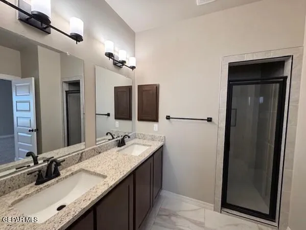 a bathroom with a double vanity sink and a mirror
