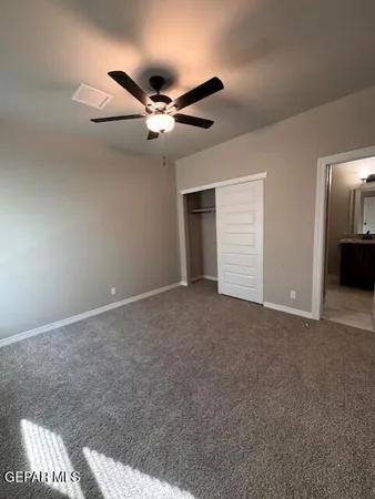 a view of a livingroom with a ceiling fan and window