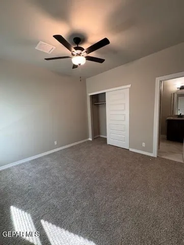 a view of a livingroom with a ceiling fan and window