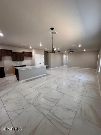 a view of a kitchen with a sink and a refrigerator