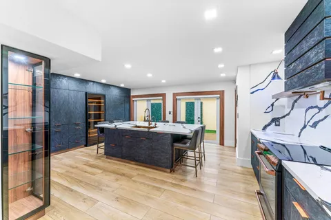 a large living room with stainless steel appliances granite countertop furniture and a fireplace