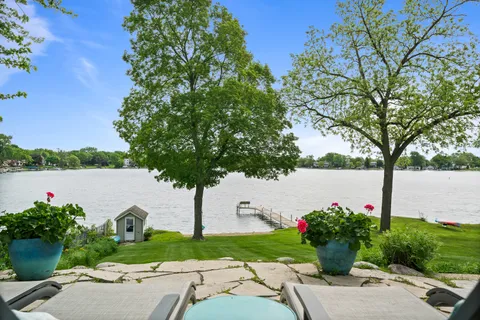 a view of a lake with a table and a potted plant