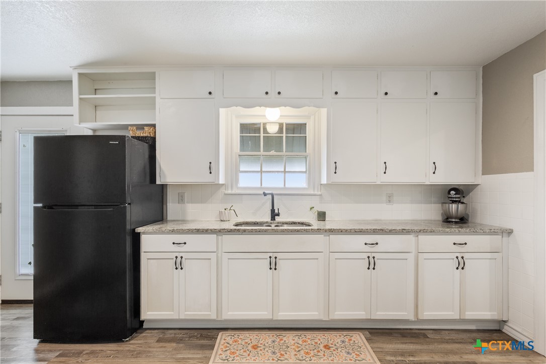 1206 Ashleman Street Waco, TX 76705 - Photo 11 of 26 a kitchen with a refrigerator sink and cabinets