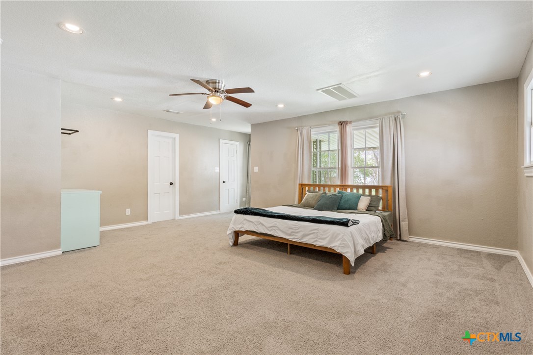 1206 Ashleman Street Waco, TX 76705 - Photo 13 of 26 a bedroom with furniture and a ceiling fan