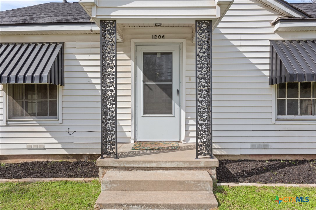 1206 Ashleman Street Waco, TX 76705 - Photo 4 of 26 a front view of a house with a white door