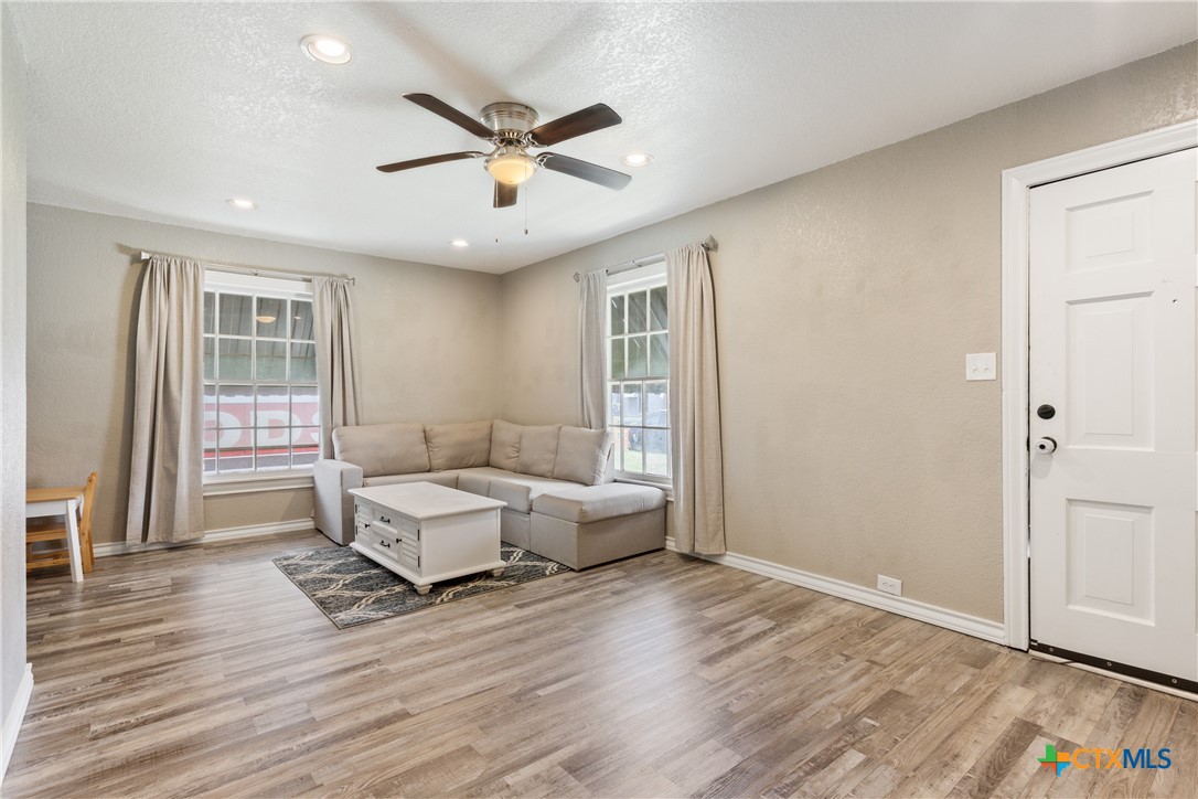 1206 Ashleman Street Waco, TX 76705 - Photo 6 of 26 a living room with furniture and a wooden floor