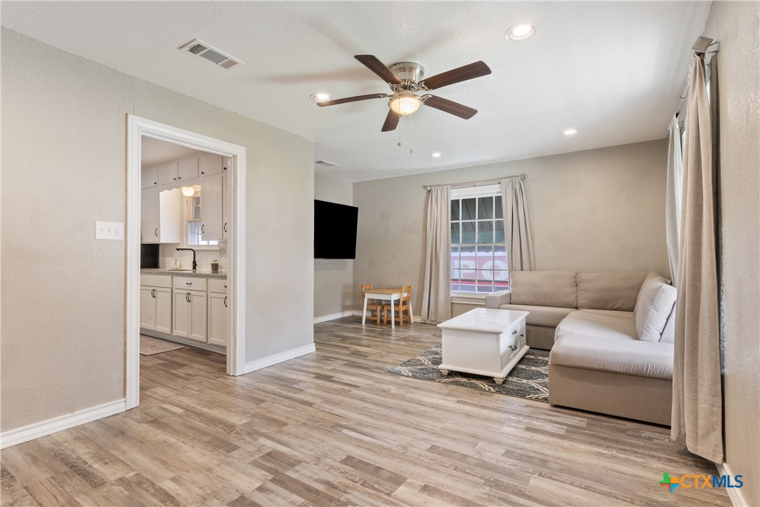 1206 Ashleman Street Waco, TX 76705 - Photo 7 of 26 a living room with furniture and a wooden floor
