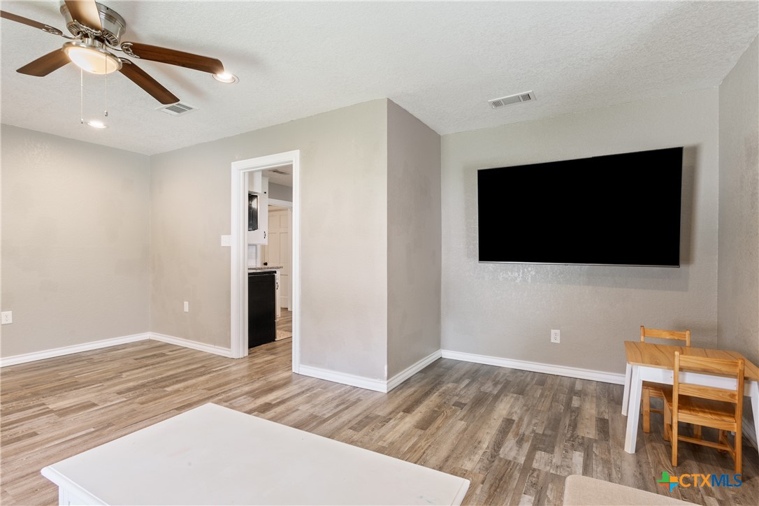 1206 Ashleman Street Waco, TX 76705 - Photo 8 of 26 a bedroom with a bed and a flat screen tv