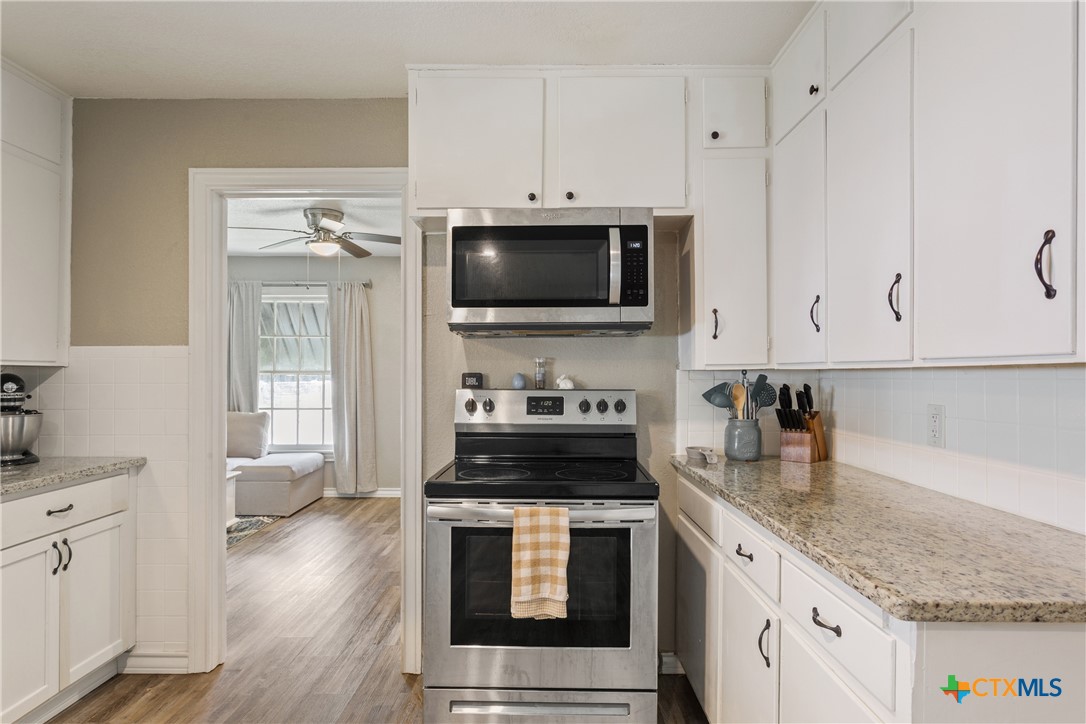 1206 Ashleman Street Waco, TX 76705 - Photo 10 of 26 a kitchen with granite countertop a stove and a sink