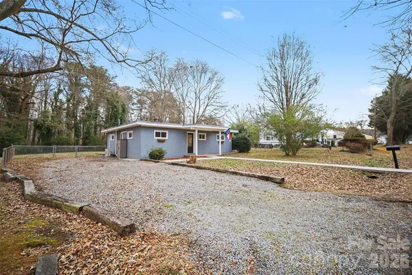 a view of a house with a yard and garage