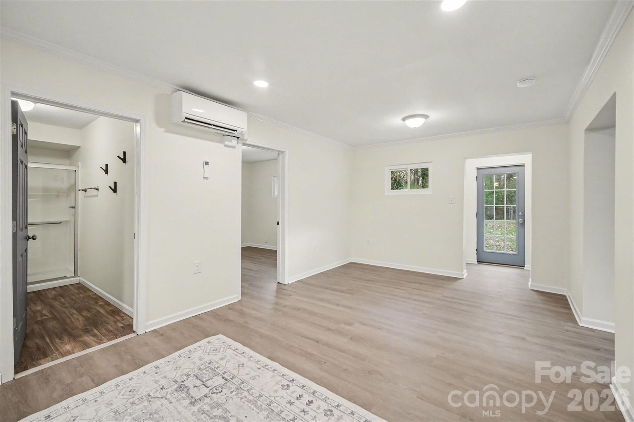 112 Lineberger Street Stanley, NC 28164 - Photo 15 of 32 an empty room with wooden floor and a bathroom
