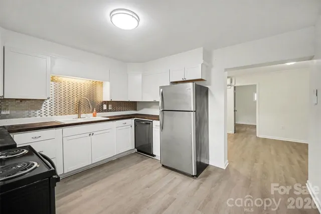 a kitchen with a refrigerator sink and stove