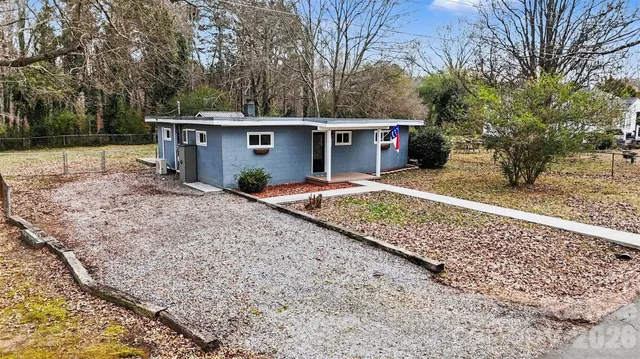 a view of house with backyard and seating space